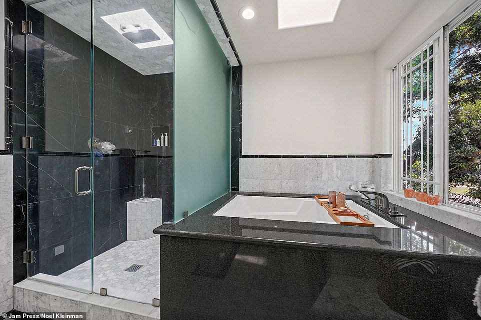 The luxurious spa-inspired bathroom includes dual vanities plus a separate jacuzzi spa tub and steam shower.