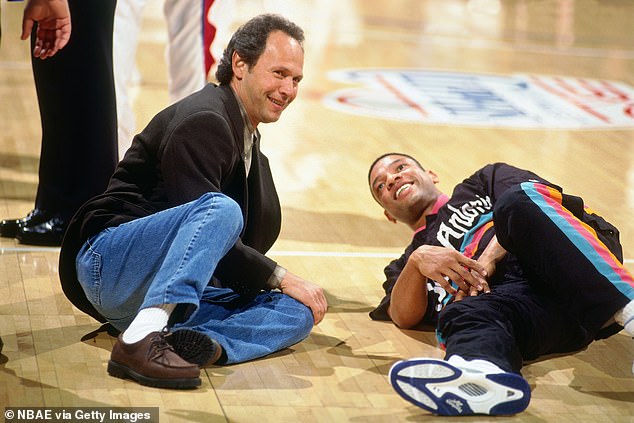 Billy Crystal speaks with his friend and former Clippers guard Doc Rivers in 1995