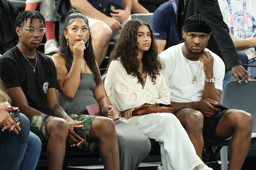 Bryce James (L), Sadie Johnson, Parker Whitfield and Bronny James (R), at the men's basketball semifinals match between Team USA and Team Serbia at Bercy Arena on August 8, 2024 in Paris, France.