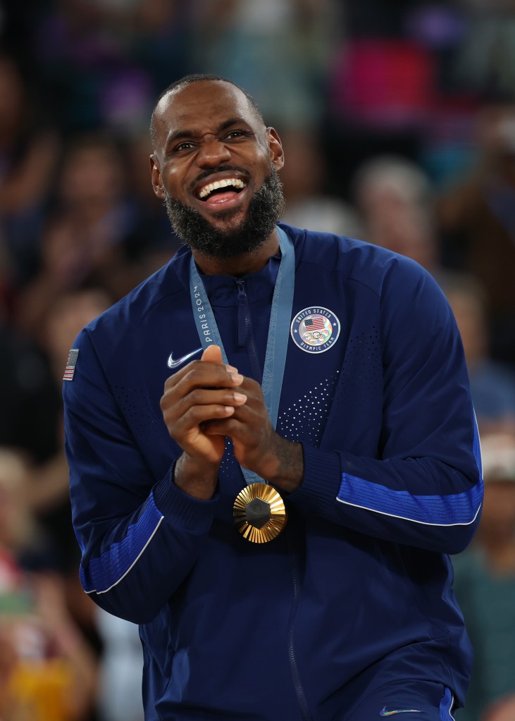 LeBron James celebrates on the podium during the men's basketball medal ceremony at Bercy Arena on August 10, 2024 in Paris, France.