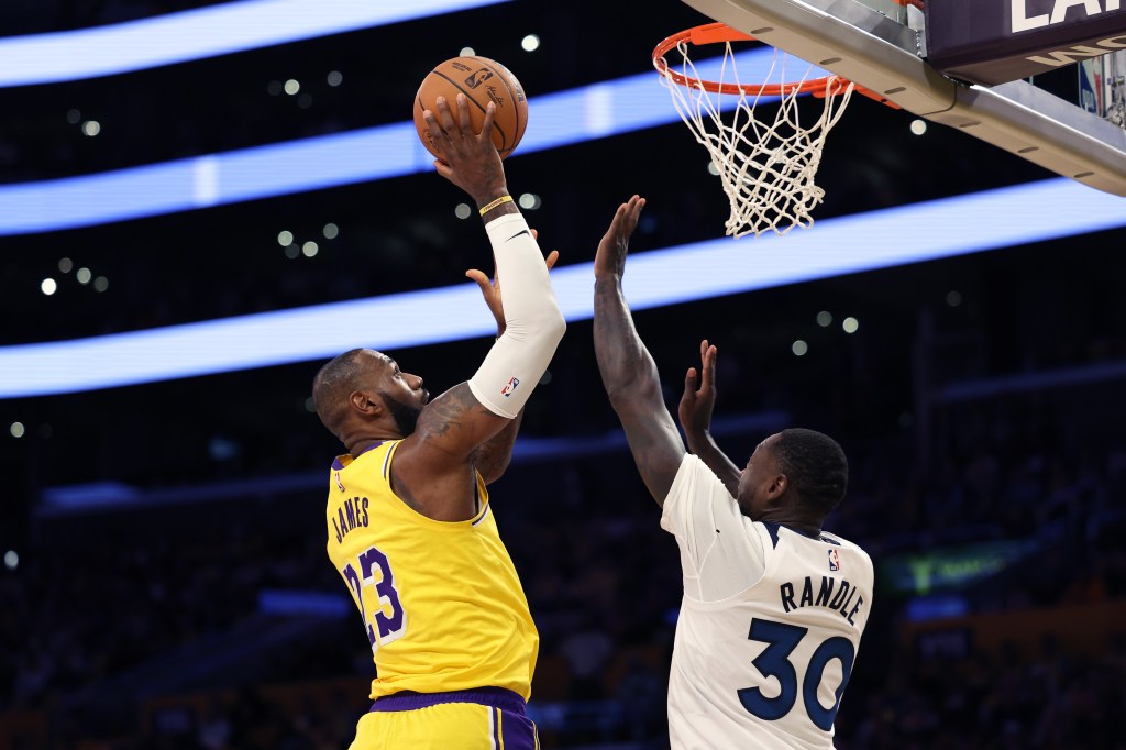 LeBron James challenges Julius Randle at the rim.