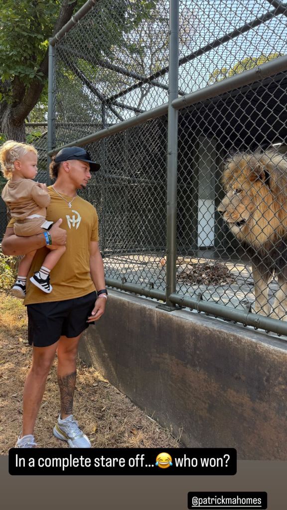 Patrick Mahomes holding son Bronze next to a lion in a photo taken Oct. 10.