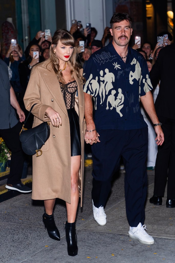 Taylor Swift and Travis Kelce walking to dinner and holding hands