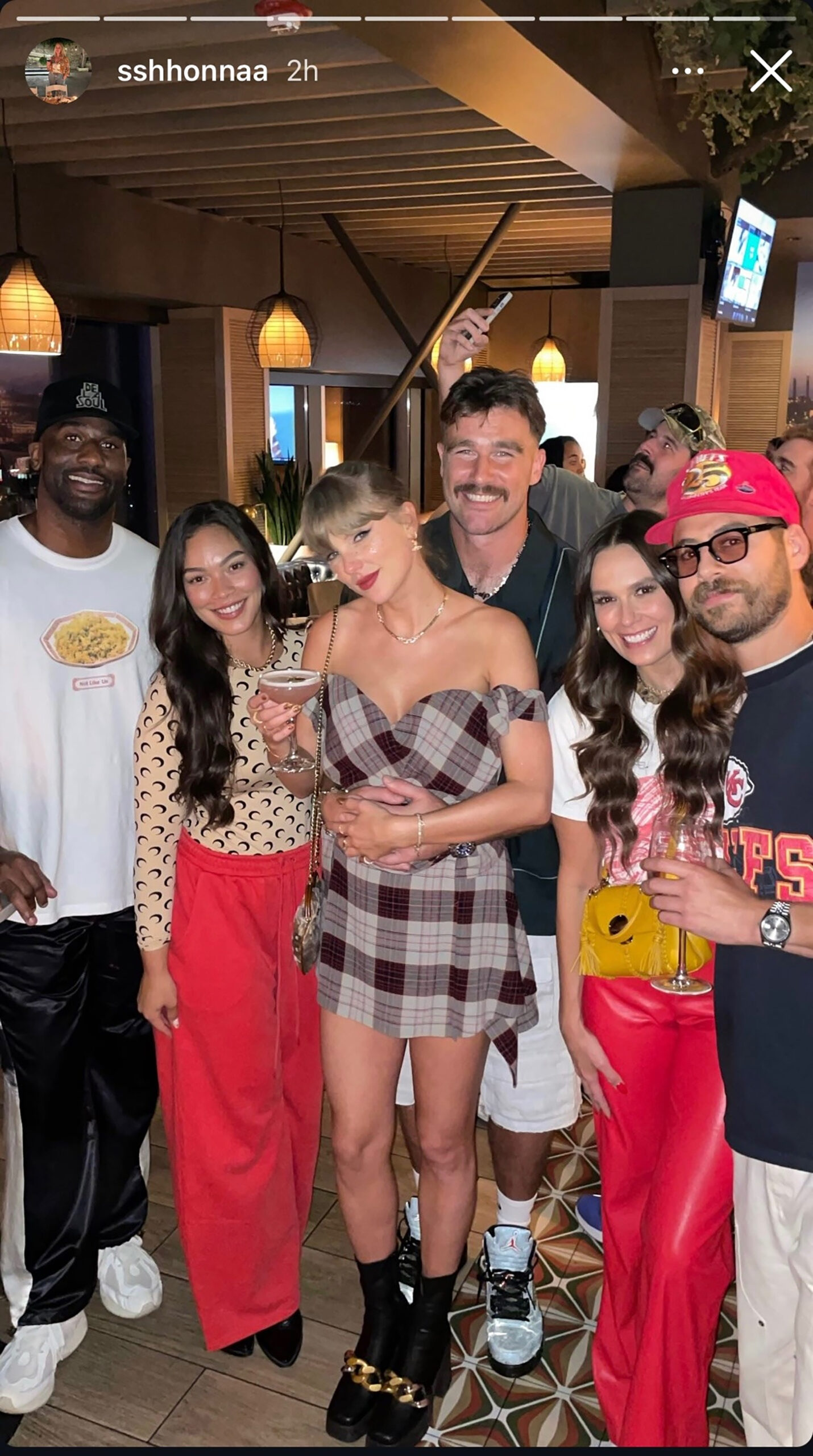 Taylor Swift and Travis Kelce at a Chiefs game afterparty.