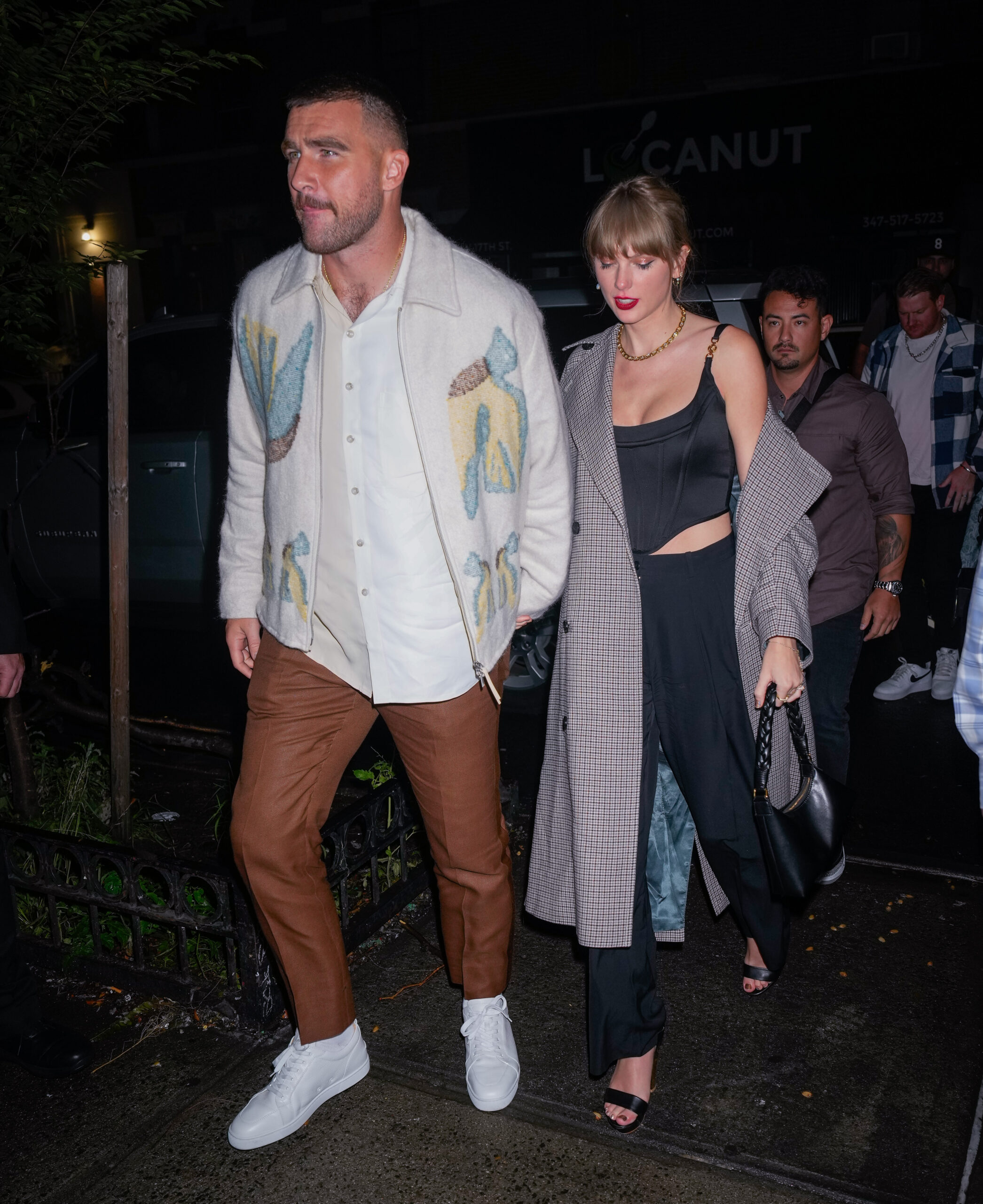 Travis Kelce and Taylor Swift holding hands in October 2023.