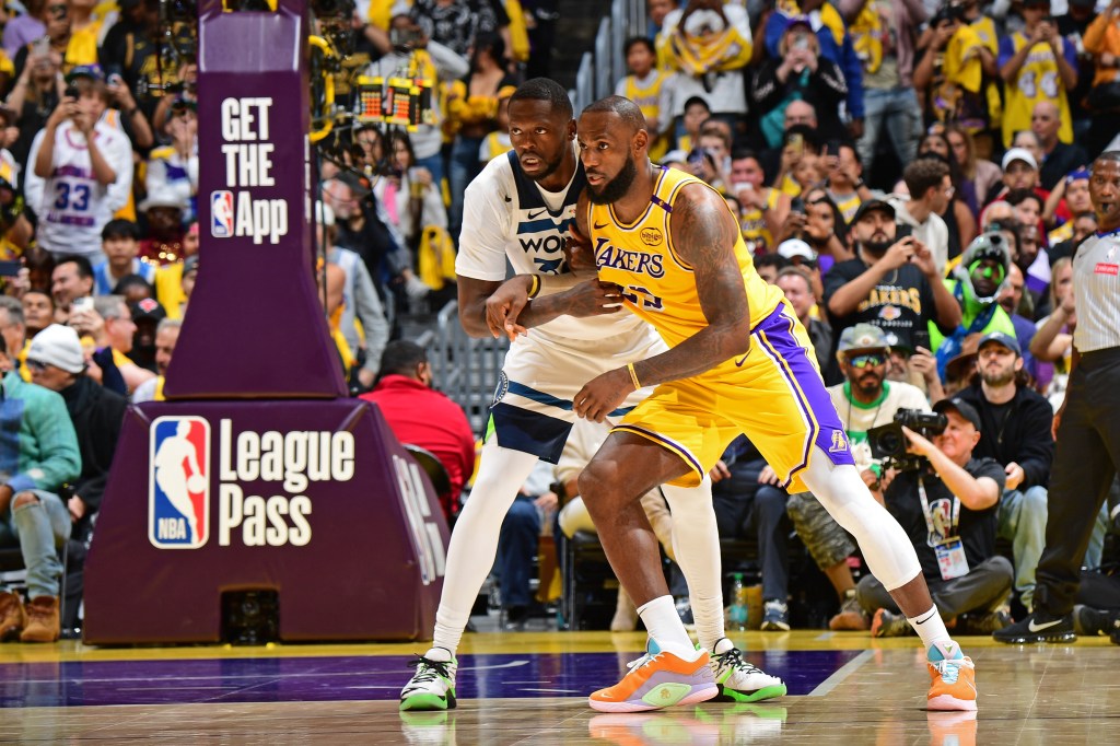 Julius Randle of the Minnesota Timberwolves and LeBron James of the Los Angeles Lakers look on during the game on October 22, 2024.