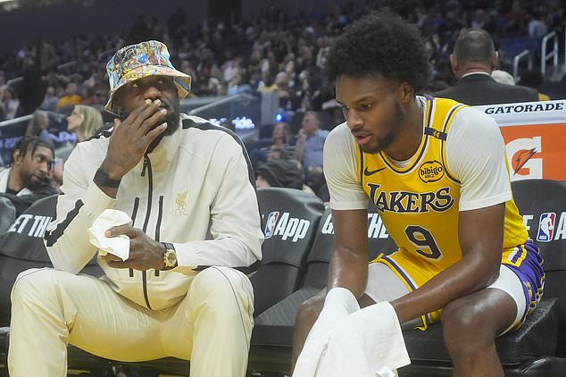 Los Angeles Lakers forward LeBron James, left, talks with guard Bronny James during the second half of an NBA preseason basketball game against the Golden State Warriors in San Francisco, Friday, Oct. 18, 2024. (AP Photo/Jeff Chiu)