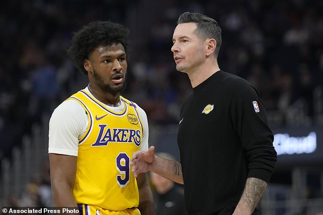 Los Angeles Lakers head coach JJ Redick, right, talks with Los Angeles Lakers guard Bronny James (9) during the first half of an NBA preseason basketball game against the Golden State Warriors in San Francisco, Friday, Oct. 18, 2024. (AP Photo/Jeff Chiu)